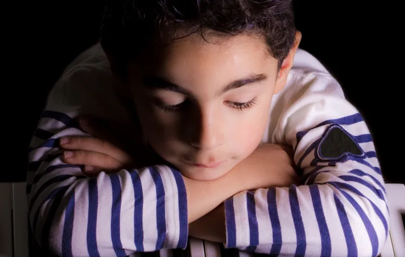 A young pianist focused on the keys.